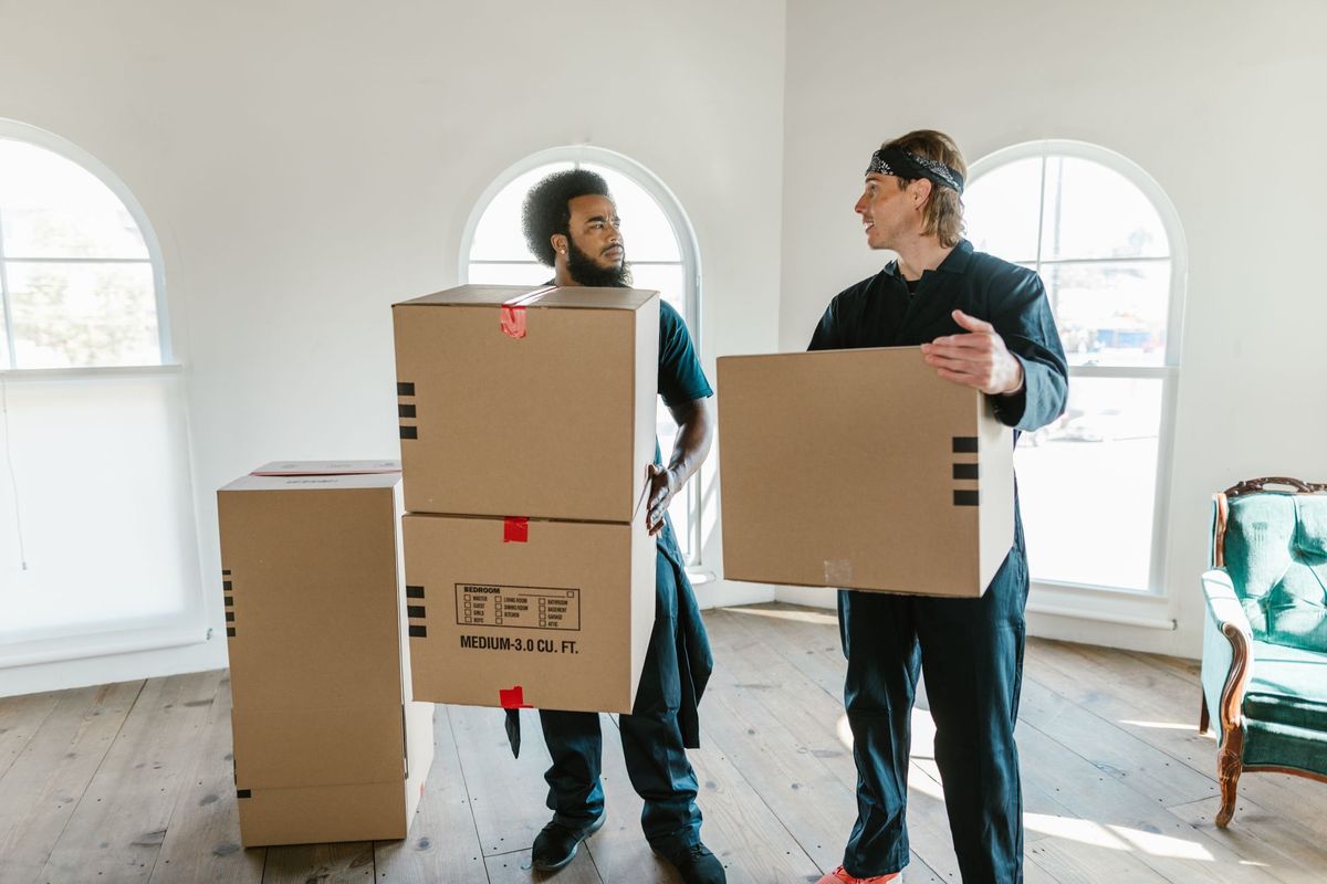 Moving team loading boxes outside a Pleasant Grove Dallas home