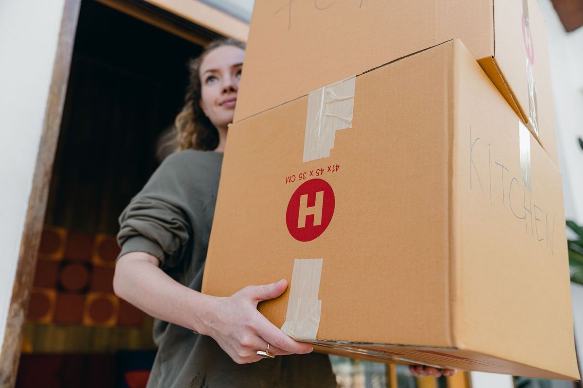 Movers carefully carrying furniture from a Lakewood Dallas home