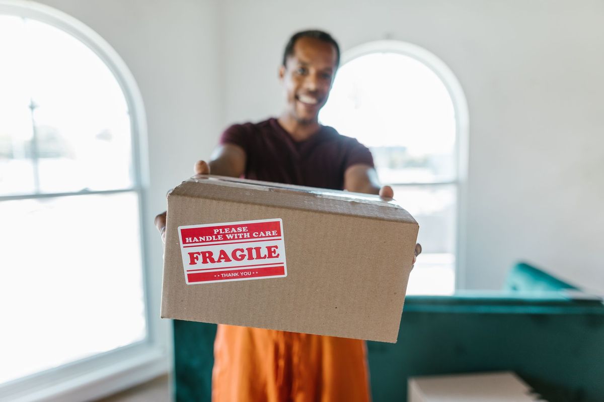 Movers handling household furnishings at a Preston Hollow Dallas residence