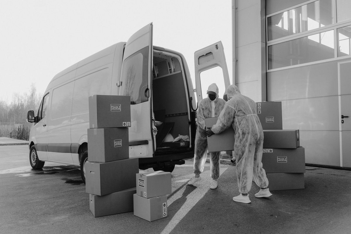 Moving professionals loading boxes into a truck near a Lake Highlands home
